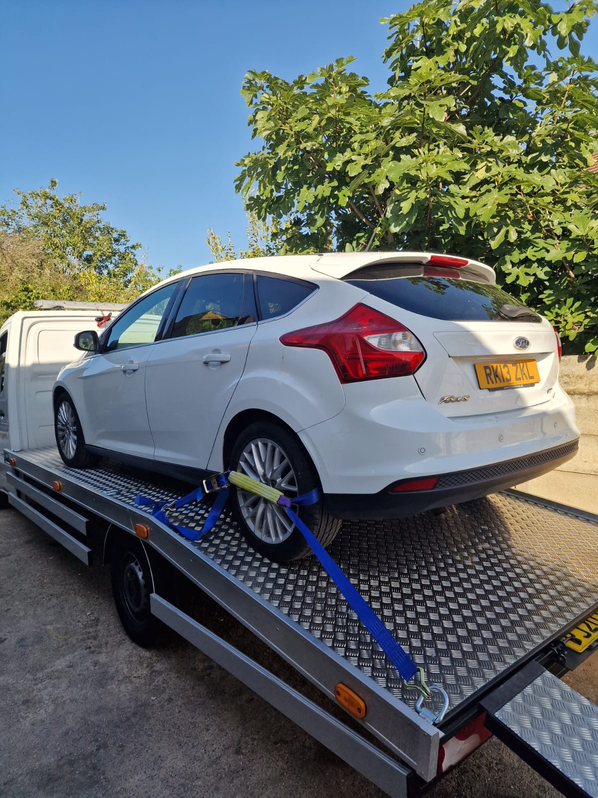Vehicle secured on flatbed tow truck